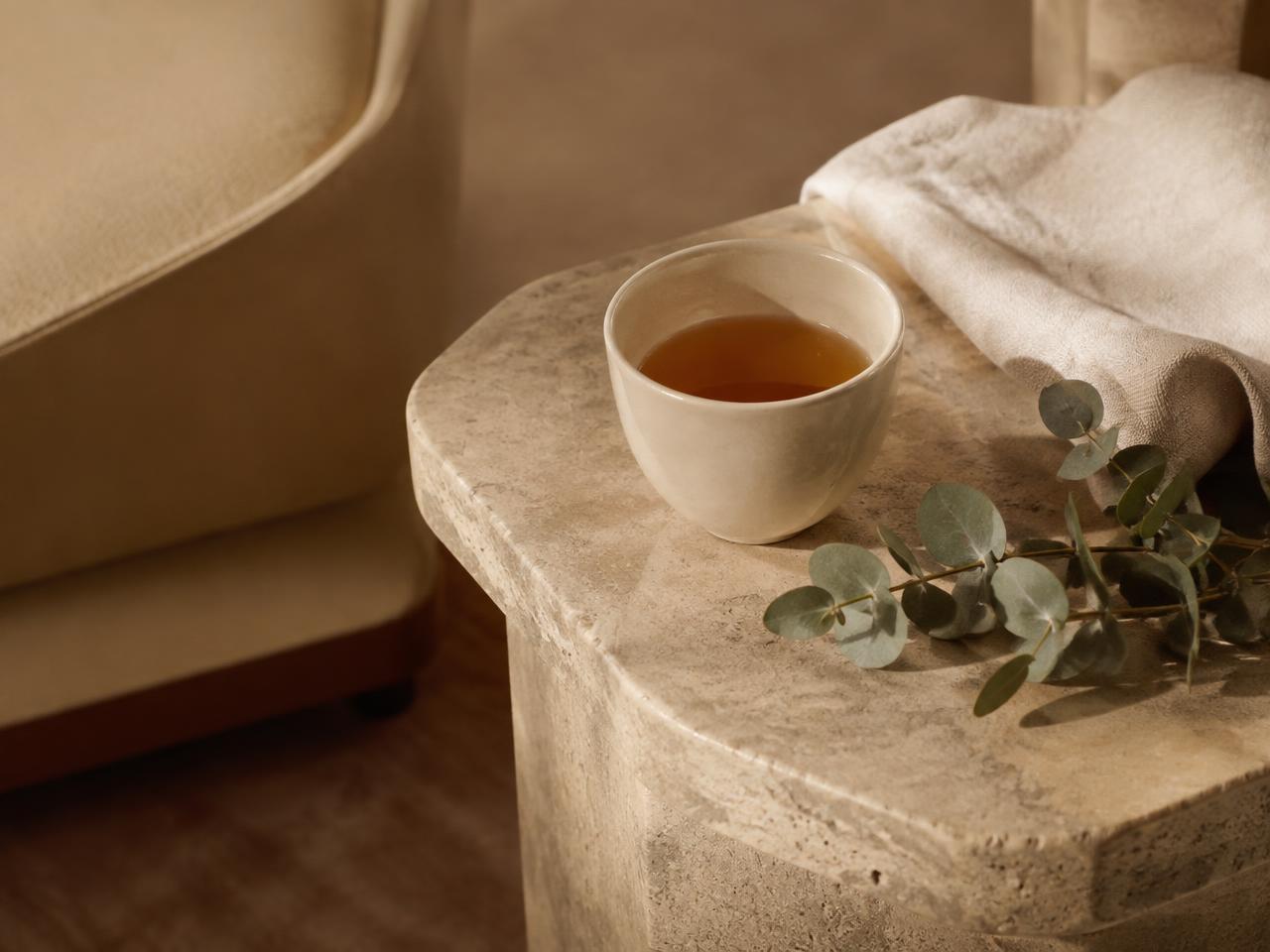 Tea and linen on a travertine side table in the patient lounge